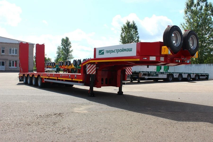 Heavy-duty Semi-Trailer TverstroyMash 993941 Modification 0023 with Hydraulic Double Folding Ramps