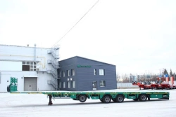 Heavy-Duty Platform Semi-Trailer TverstroyMash 993941 Modification 0022 with Fittings and Side Ramps